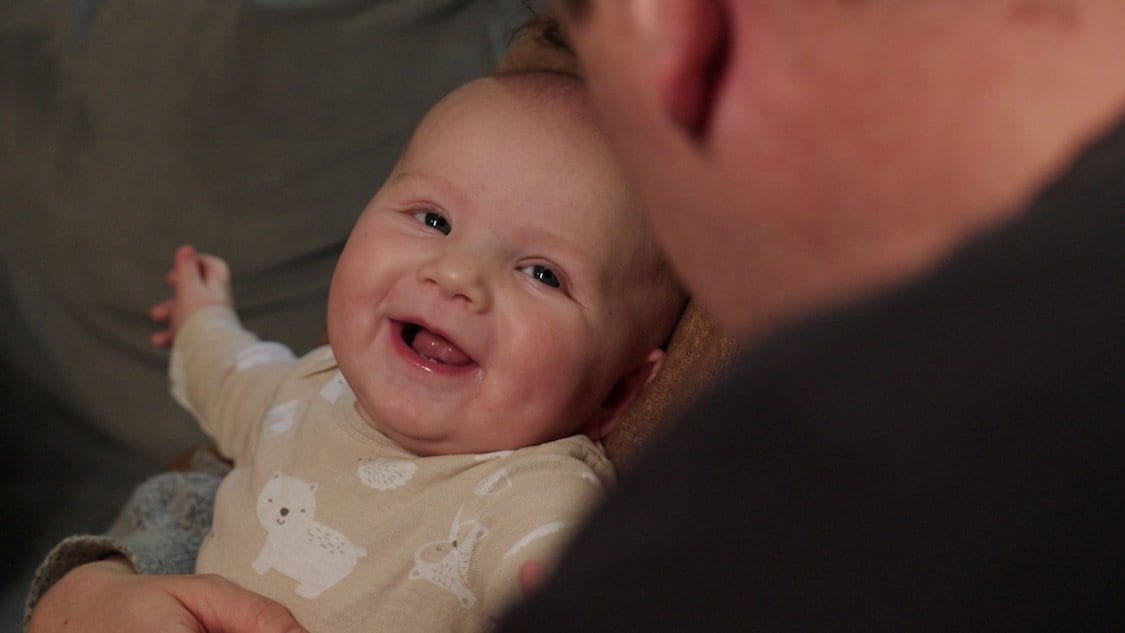 Baby Charlie smiling with dad