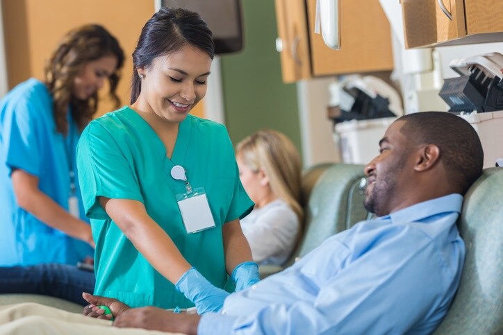 Man having blood drawn by a nurse