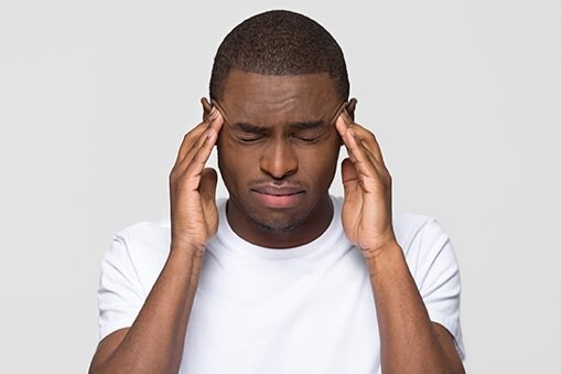 African American man rubbing his temples