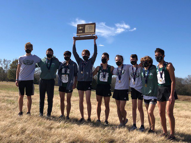 Free State High School boys cross country team lifts 6A state championship trophy