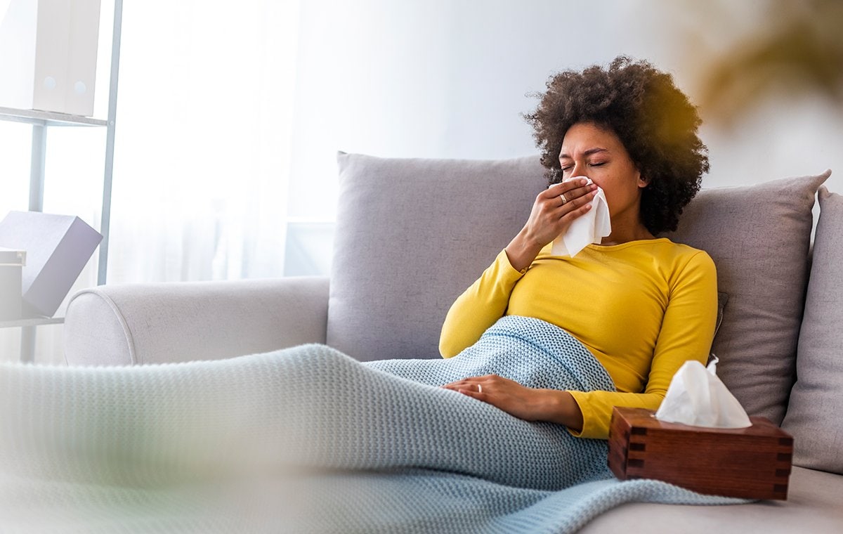 woman on couch ill 