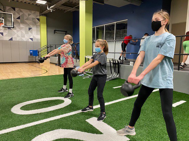 L-R: Abbie Veeder, Addy Tenbrink and Landry Koester perform kettlebell swings