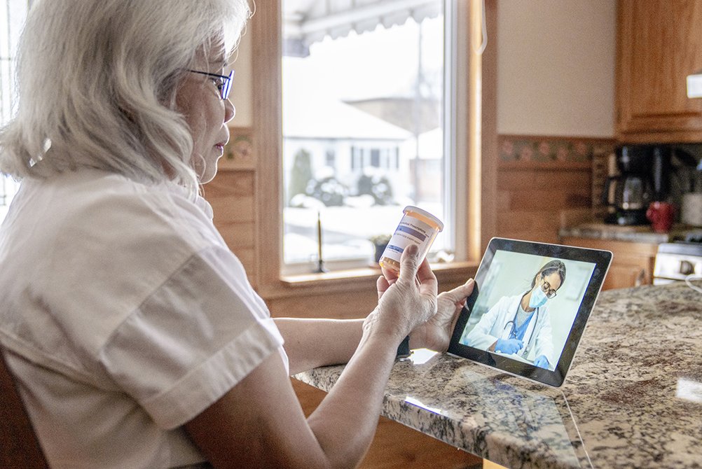 Medicare patient reviews medications with LMH Health physician using telemedicine