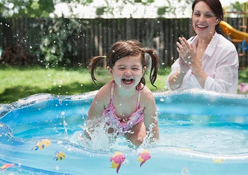 Girl splashing in baby pool