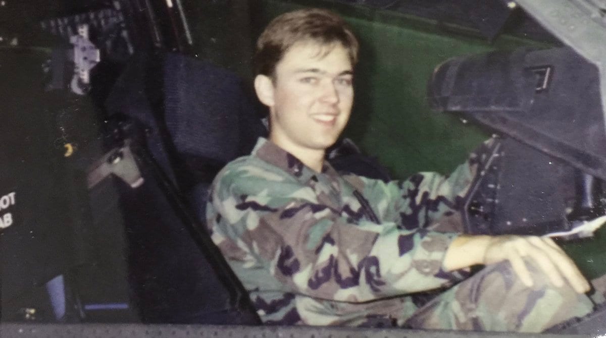 Kirk Sloan sits in a helicopter cockpit in 1997