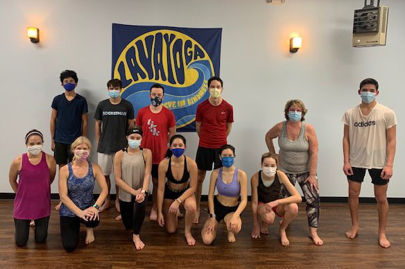 RunStrong students and adults attend a yoga class at Lava Yoga