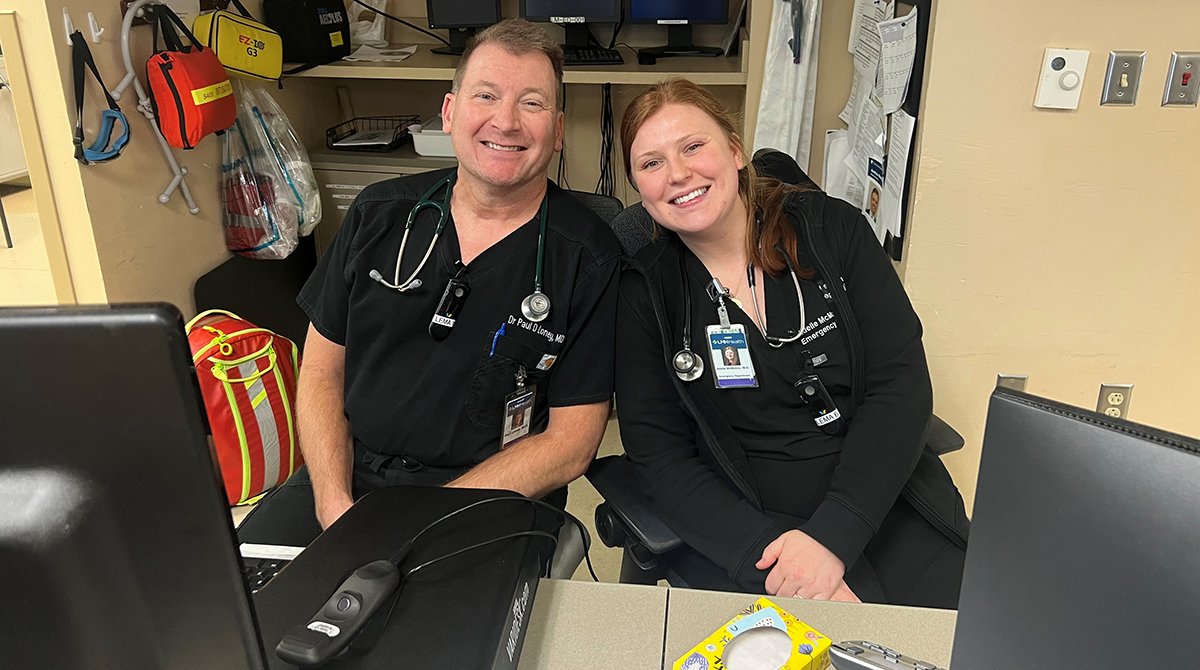 Dr. Paul Loney and Dr. Adelle McMahon pose for a photo in the ED in 2023