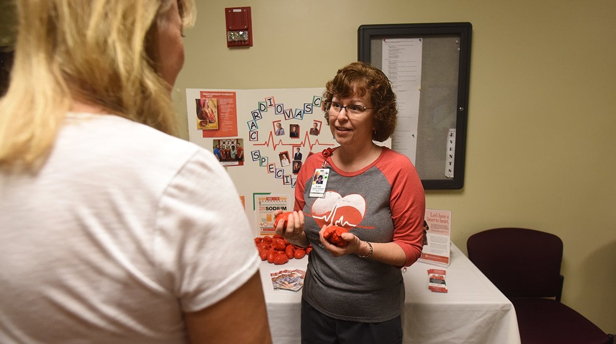 Lorie Sawyer talks with a participant at the Health Fair