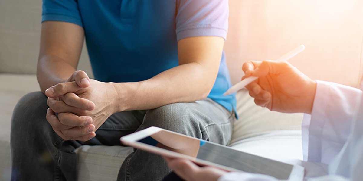 Male patient consulting with provider