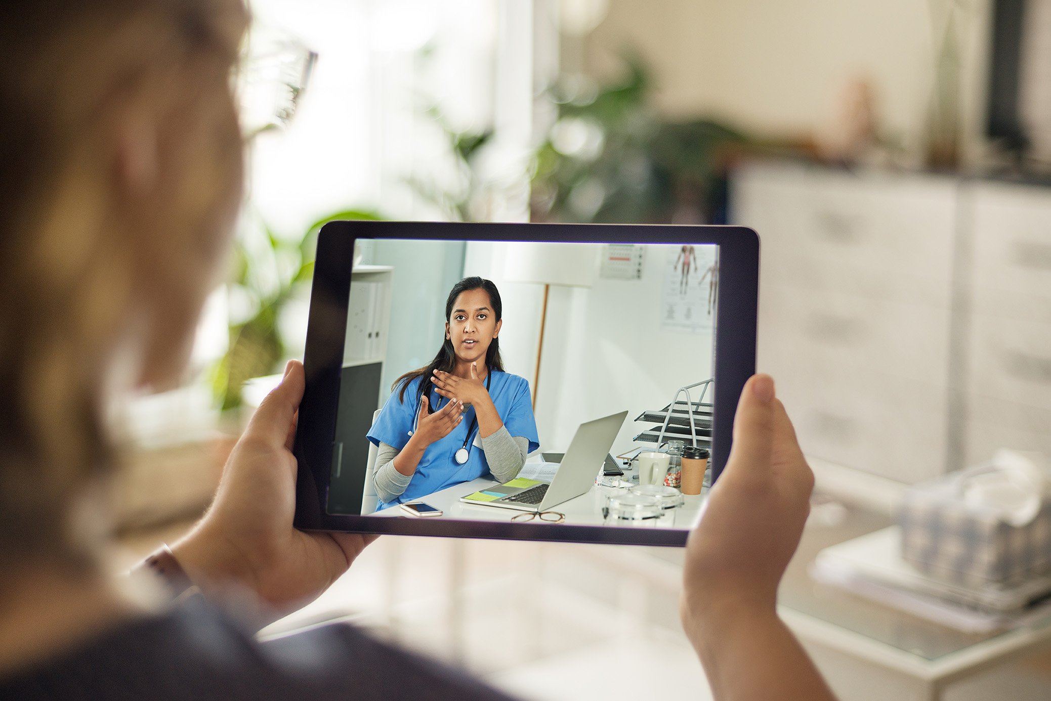 Woman holding an iPad for telemedicine visit