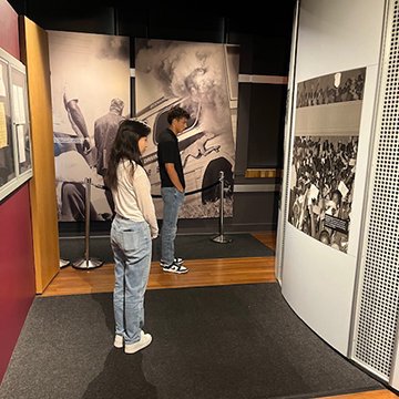 Lois Xie and Austin Drewry view an exhibit at the Brown vs. Board of Education site during June 2024